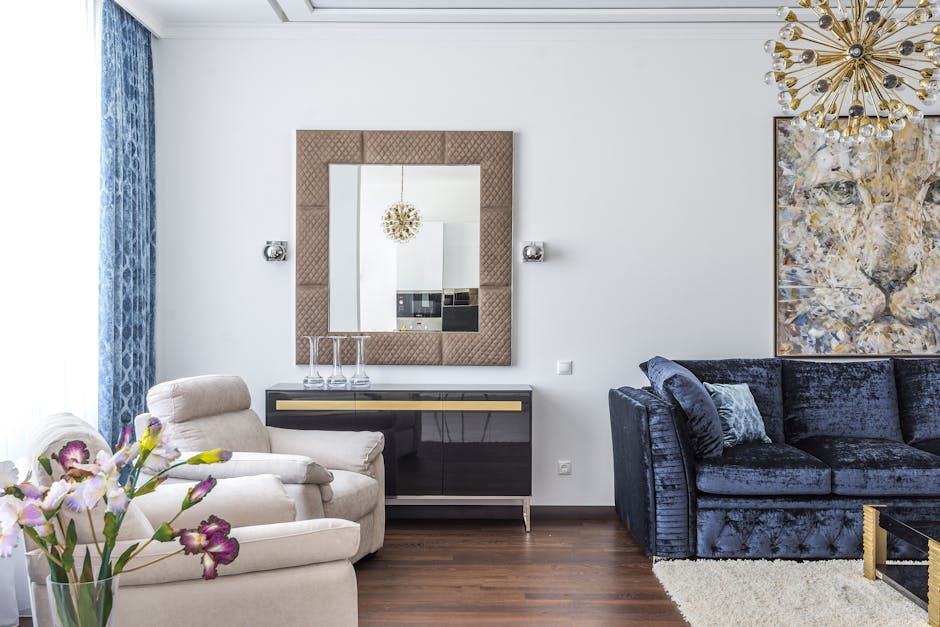 Soft comfortable couch and armchairs in interior of living room in modern apartment